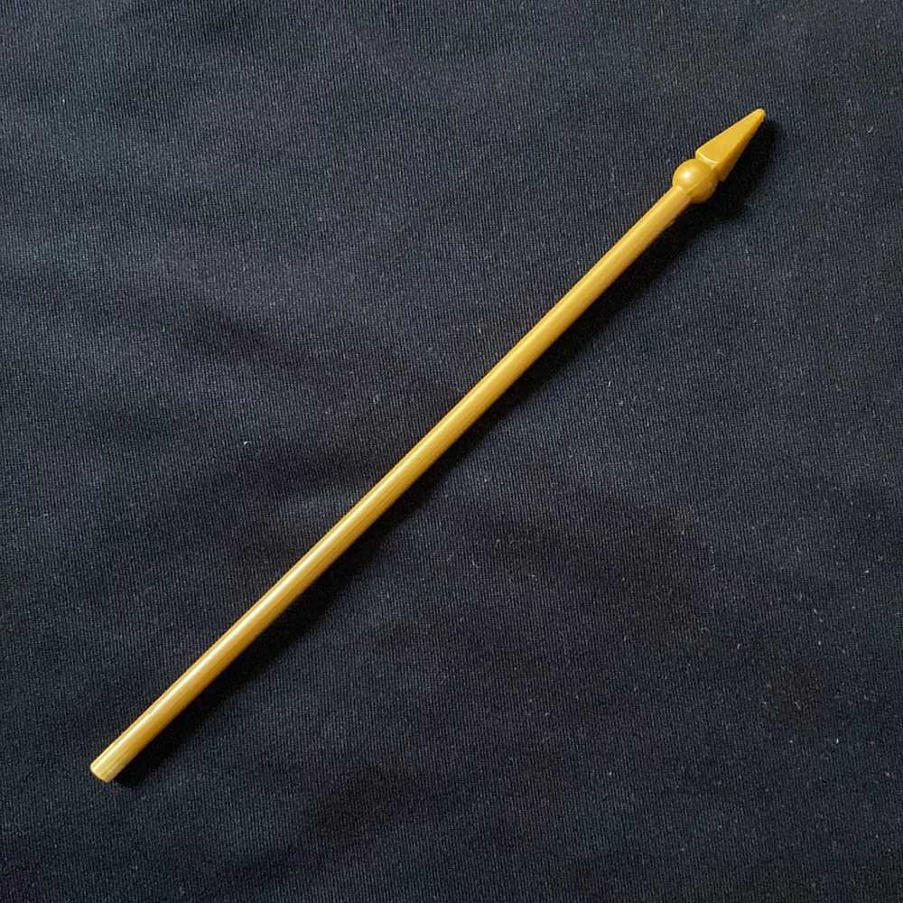 Tiny plastic golden flag staff